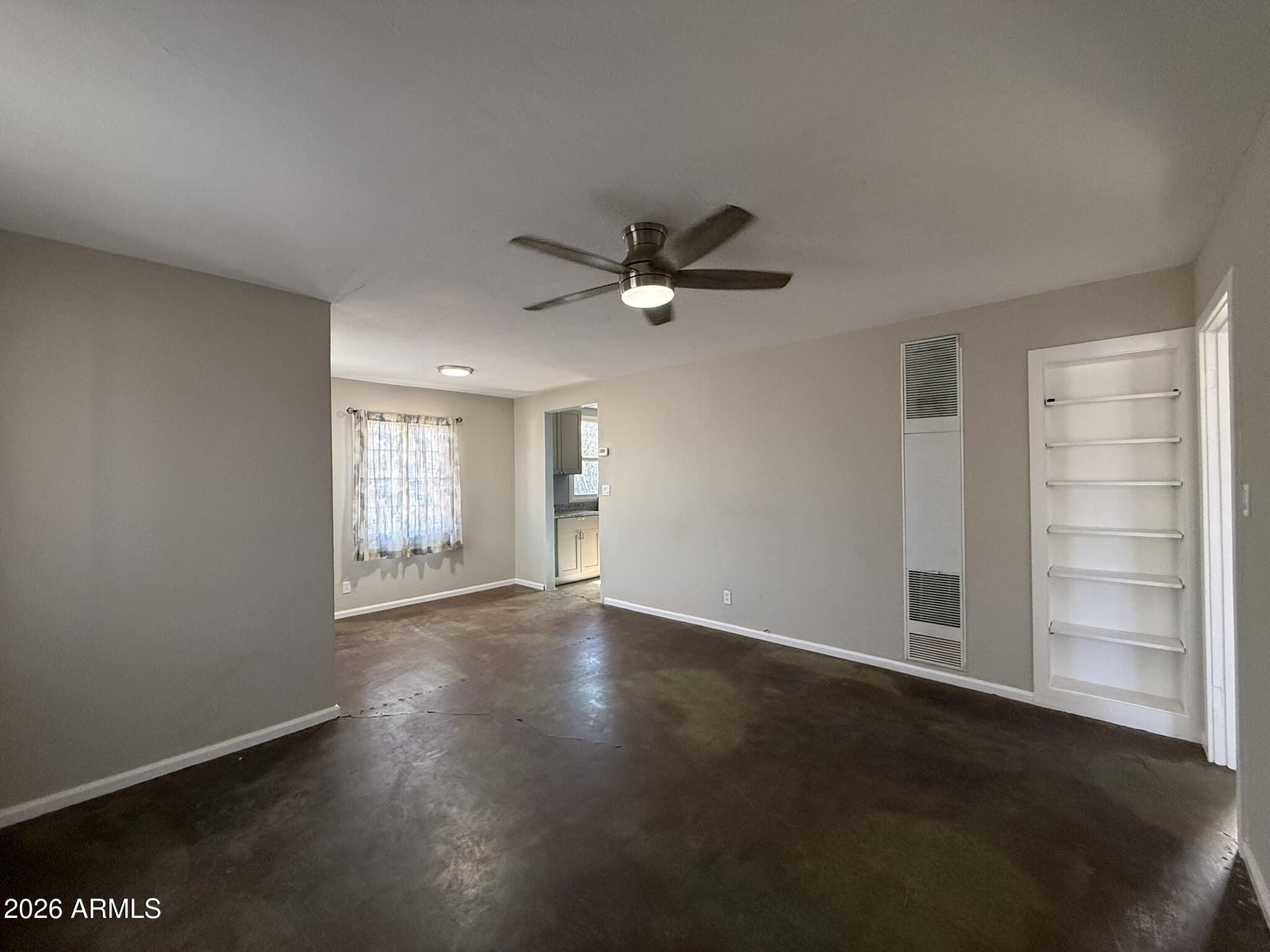 91 Neptune Avenue Bisbee, AZ 85603 - Photo 3 of 12 an empty room with windows and closet