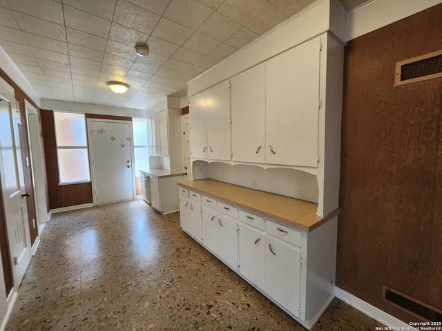 a large bathroom with a granite countertop sink and a large mirror