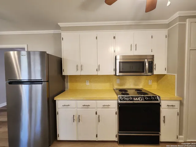 a kitchen with a stove microwave and refrigerator
