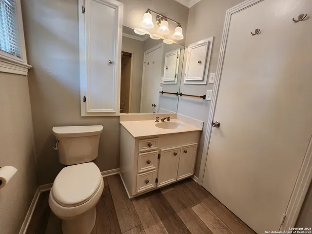 a bathroom with a toilet sink and mirror