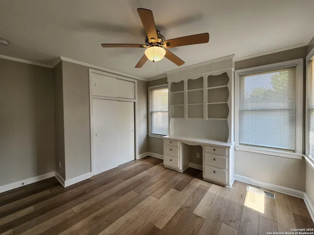 a view of a livingroom with a hardwood floor and a ceiling fan
