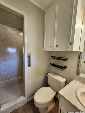 a white toilet sitting next to a bathroom sink