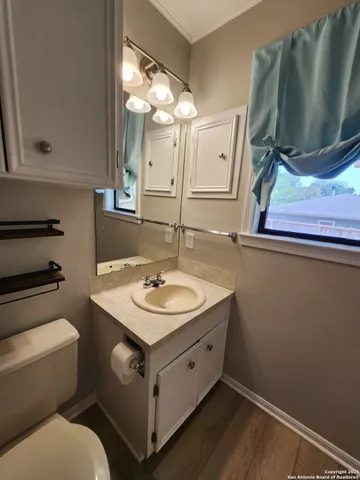 a bathroom with a toilet sink and mirror