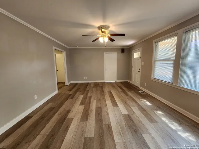 wooden floor in an empty room with a window