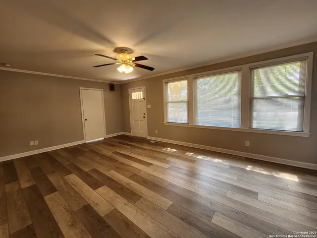 wooden floor in an empty room with a window