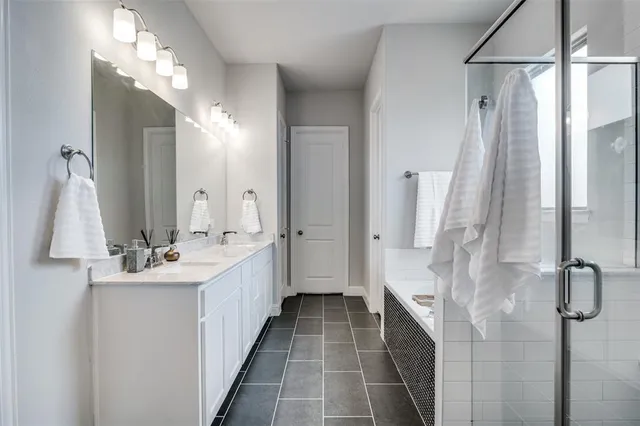 a bathroom with a double vanity sink and mirror