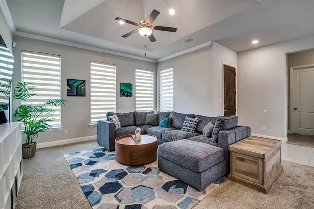 a living room with furniture and a potted plant