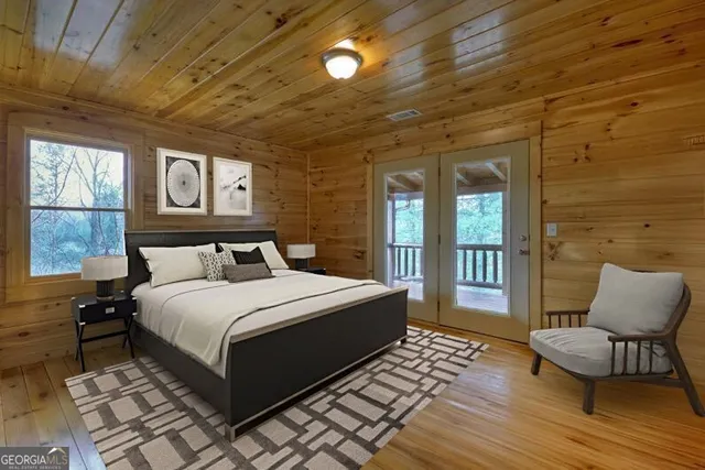 a bedroom with a bed wooden floor and window