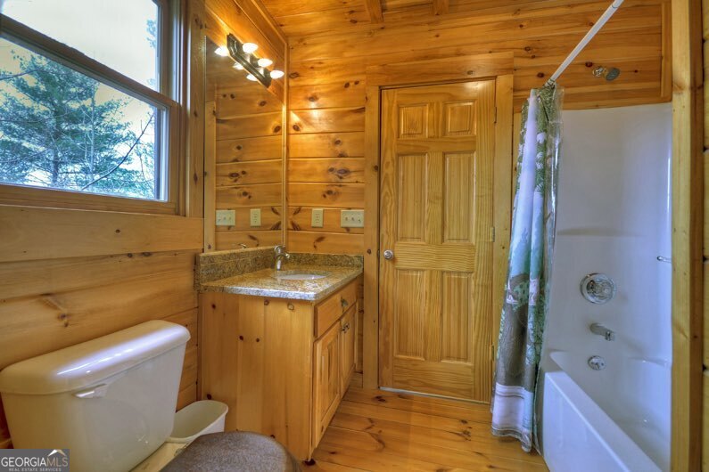 112 Seneca Drive Ellijay, GA 30540 - Photo 15 of 32 a bathroom with a granite countertop sink a toilet and shower