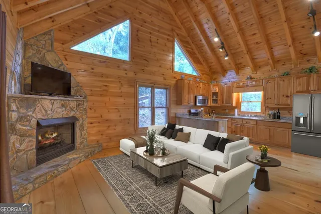 a living room with furniture a fireplace and a flat screen tv