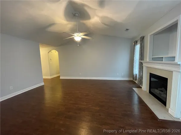 a view of livingroom with fireplace fan and window