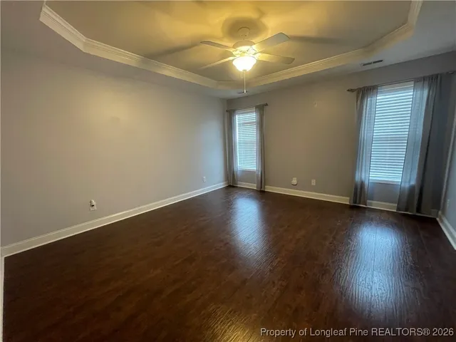 an empty room with wooden floor and window