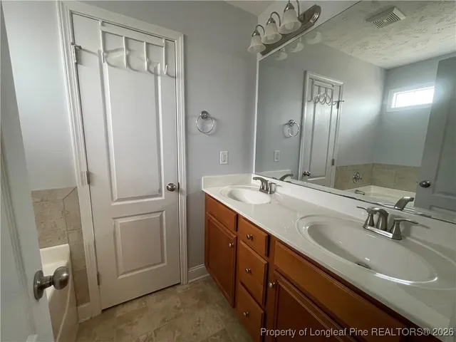 a bathroom with a double vanity sink and mirror