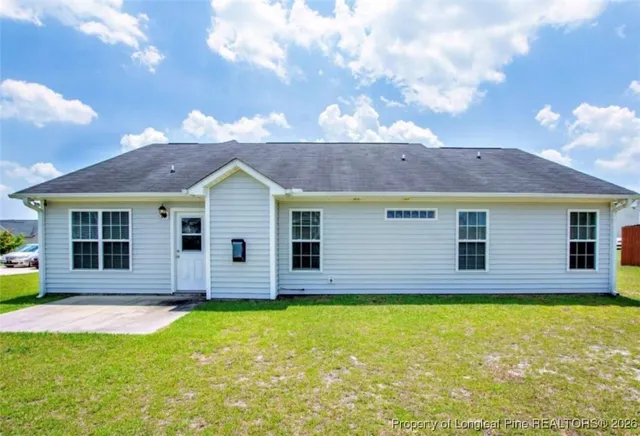 a view of a house with a backyard