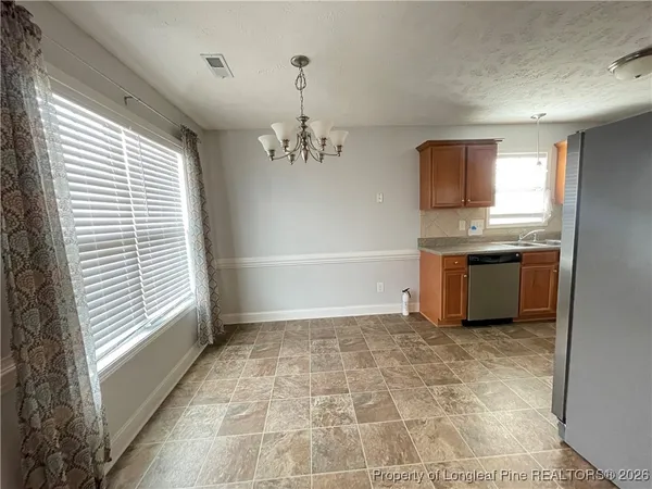 a view of a kitchen with a sink and windows