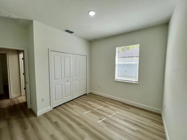 an empty room with closet area