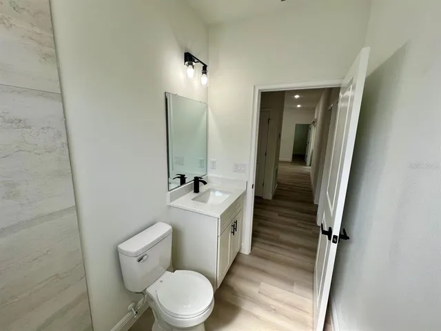 a bathroom with a toilet a sink and mirror
