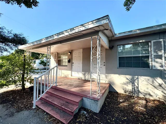 a view of a patio with table and chairs and potted plants
