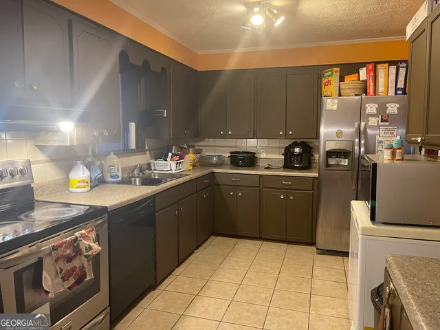 a kitchen with a sink a stove and cabinets