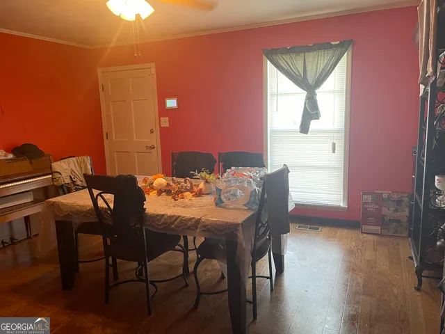 a view of a dining room with furniture and wooden floor