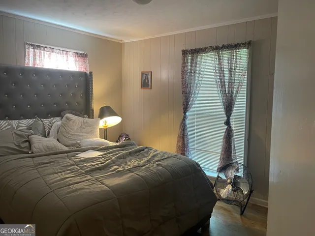 a bedroom with a bed and window