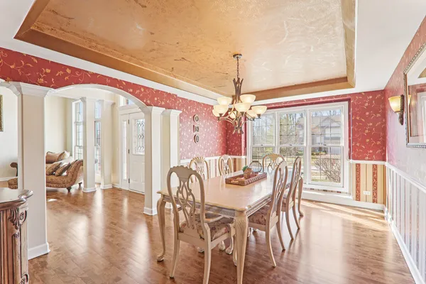 a view of a dining room with furniture wooden floor and chandelier