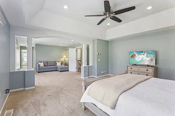 a bedroom with a bed and a chandelier