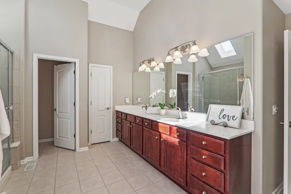 a spacious bathroom with a double vanity sink and a mirror