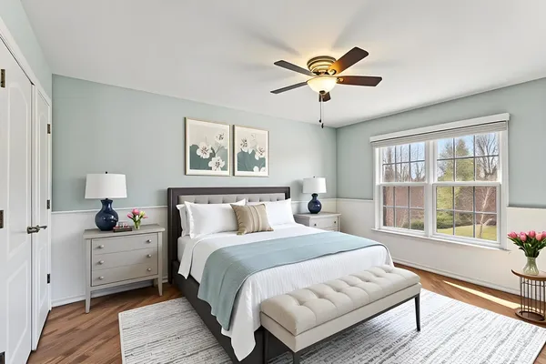 a bedroom with a large bed and a window