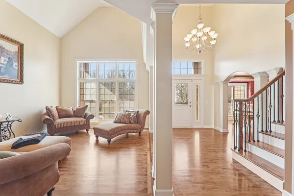 a living room with furniture and a chandelier