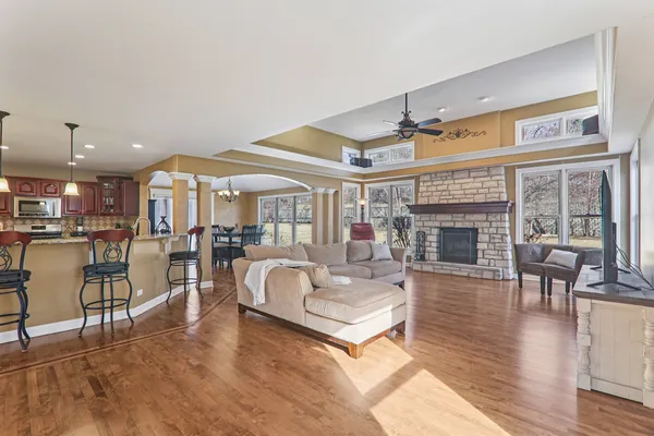a living room with furniture a fireplace and a flat screen tv