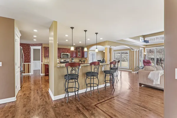 a dinning area with furniture and wooden floor