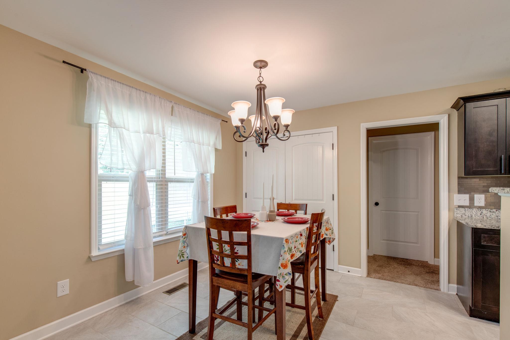 67 Remington Road Lebanon, TN 37090 - Photo 14 of 26 a dining room with furniture a chandelier and a window