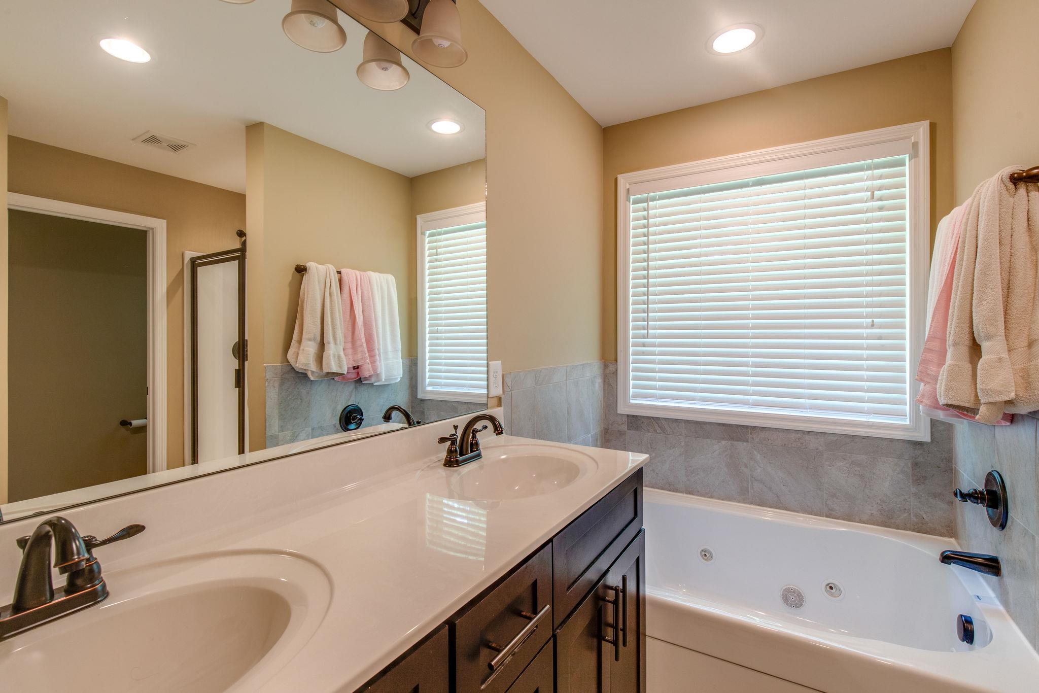 67 Remington Road Lebanon, TN 37090 - Photo 18 of 26 a bathroom with a tub sink and mirror