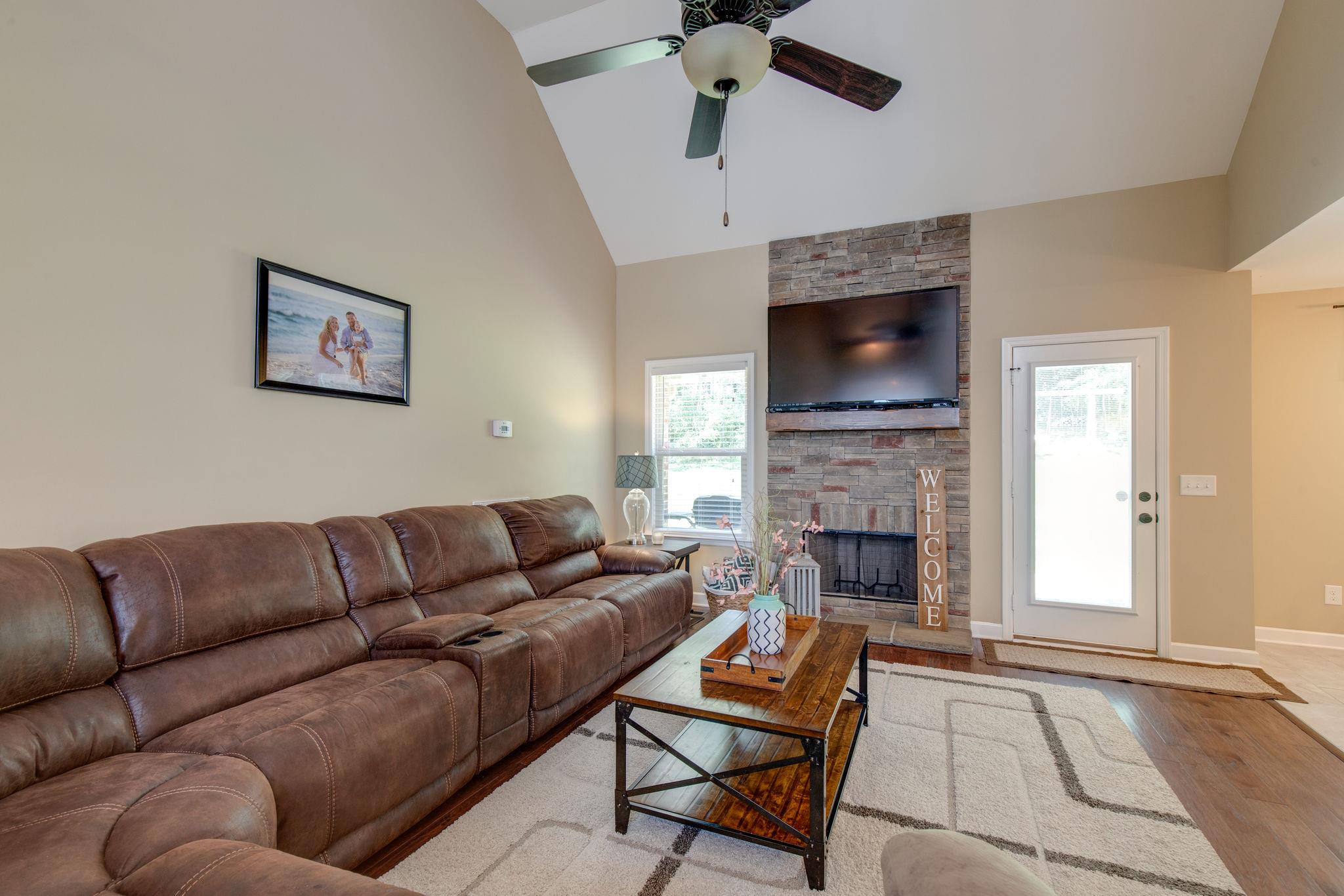 67 Remington Road Lebanon, TN 37090 - Photo 8 of 26 a living room with furniture a flat screen tv and a fireplace