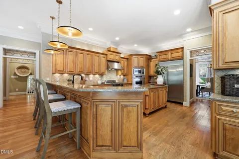 a kitchen with stainless steel appliances granite countertop a stove a sink dishwasher and a refrigerator