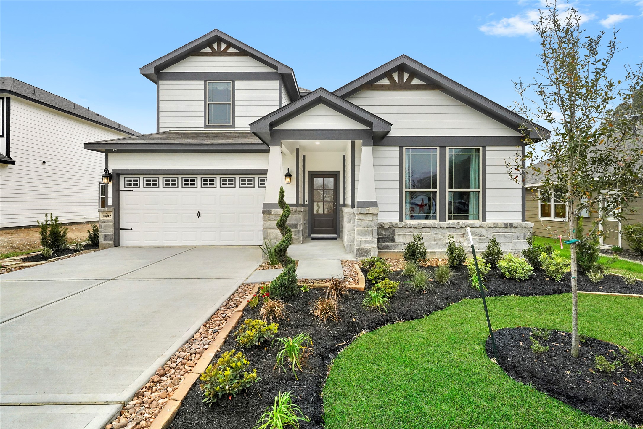 a front view of a house with a garden
