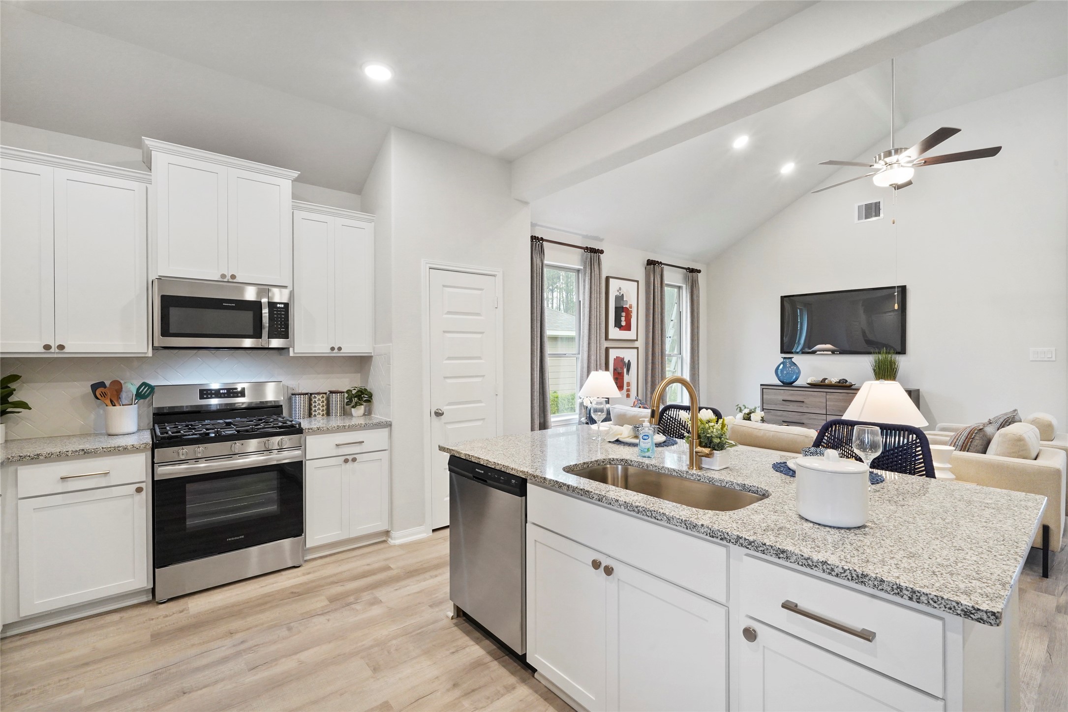 10912 Independence Road Cleveland, TX 77328 - Photo 5 of 25 a kitchen with sink a stove and cabinets