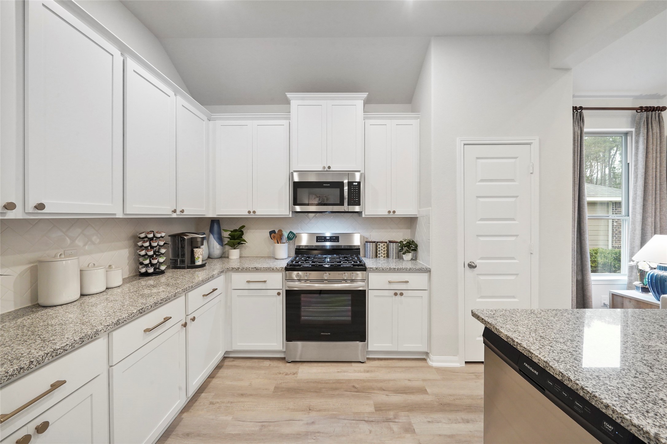 10912 Independence Road Cleveland, TX 77328 - Photo 6 of 25 a kitchen with granite countertop a stove sink and cabinets