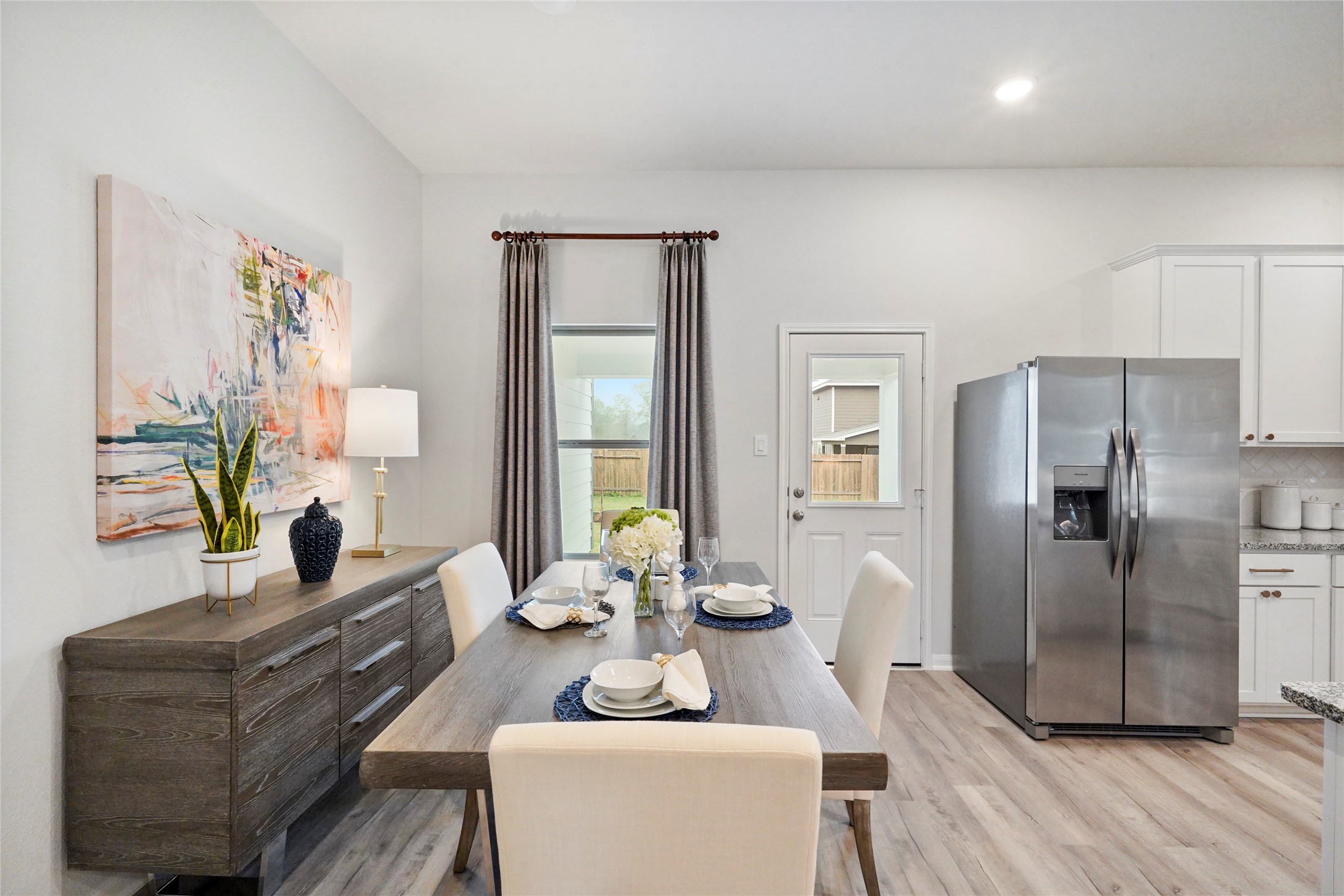 10912 Independence Road Cleveland, TX 77328 - Photo 8 of 25 a living room with furniture and a refrigerator