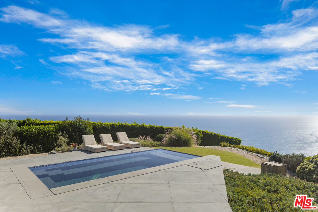22407 Carbon Mesa Road Malibu, CA 90265 - Photo 23 of 33 a view of a terrace with a garden