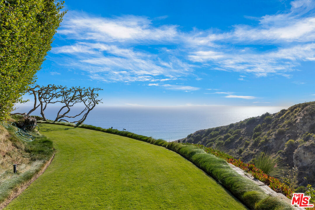 22407 Carbon Mesa Road Malibu, CA 90265 - Photo 28 of 33 a view of an ocean from a balcony