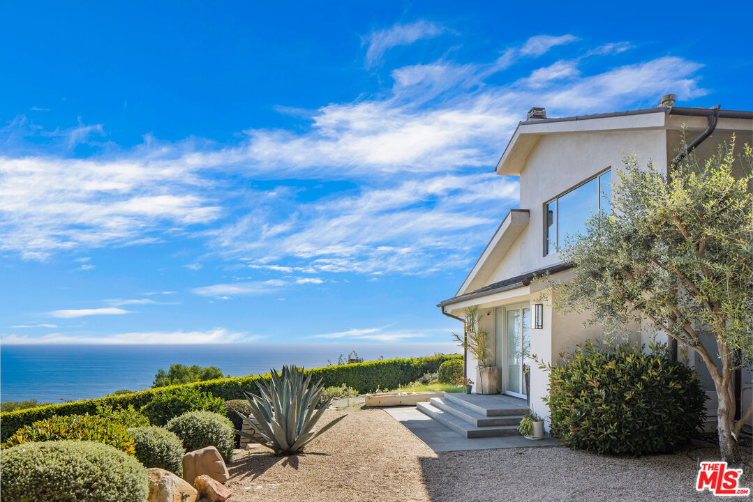 22407 Carbon Mesa Road Malibu, CA 90265 - Photo 3 of 33 a view of a house with a backyard