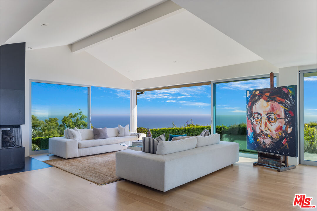 22407 Carbon Mesa Road Malibu, CA 90265 - Photo 5 of 33 a living room with furniture and a flat screen tv