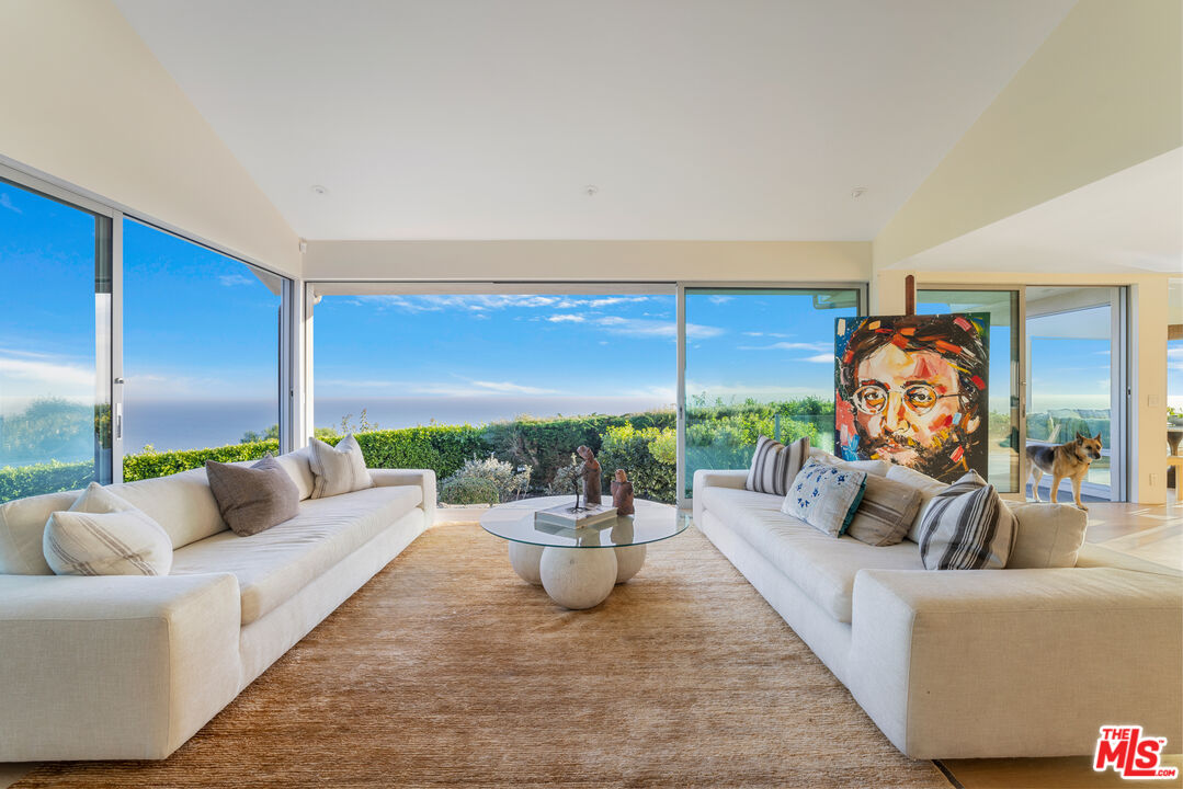 22407 Carbon Mesa Road Malibu, CA 90265 - Photo 6 of 33 a living room with furniture and a potted plant