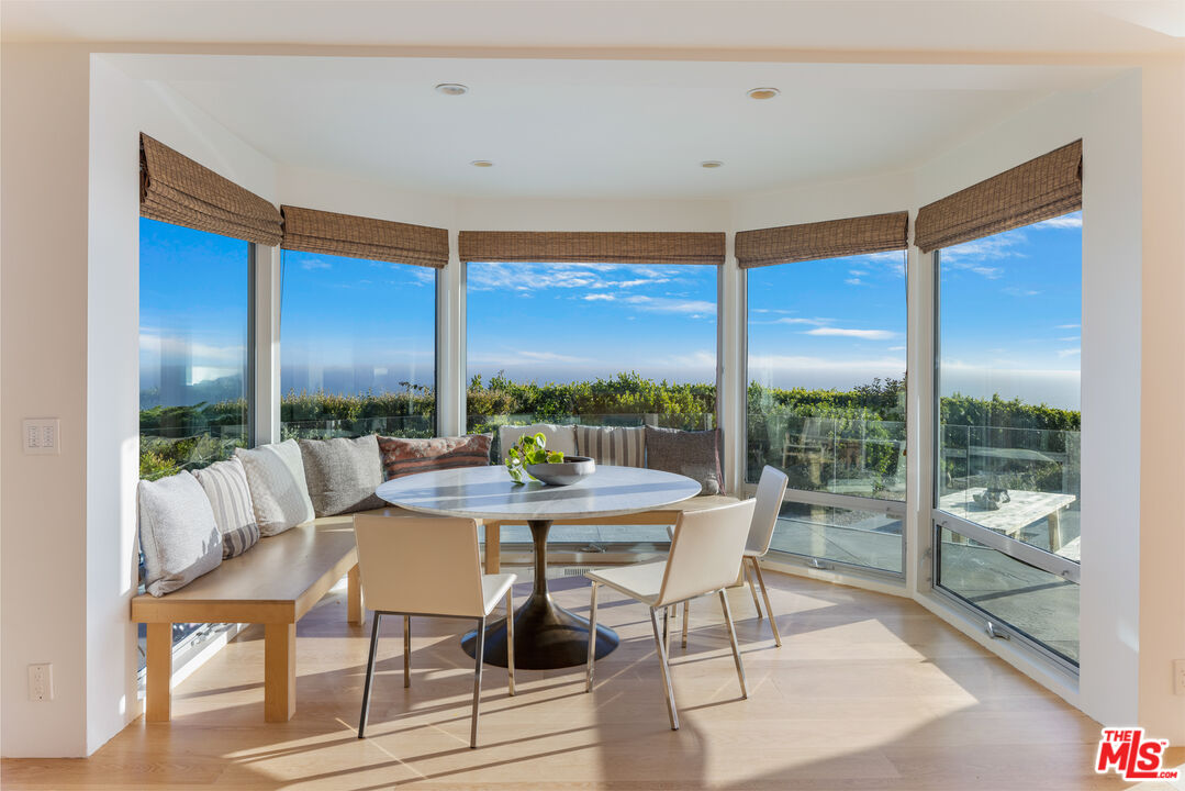 22407 Carbon Mesa Road Malibu, CA 90265 - Photo 7 of 33 a living room with furniture and a large window