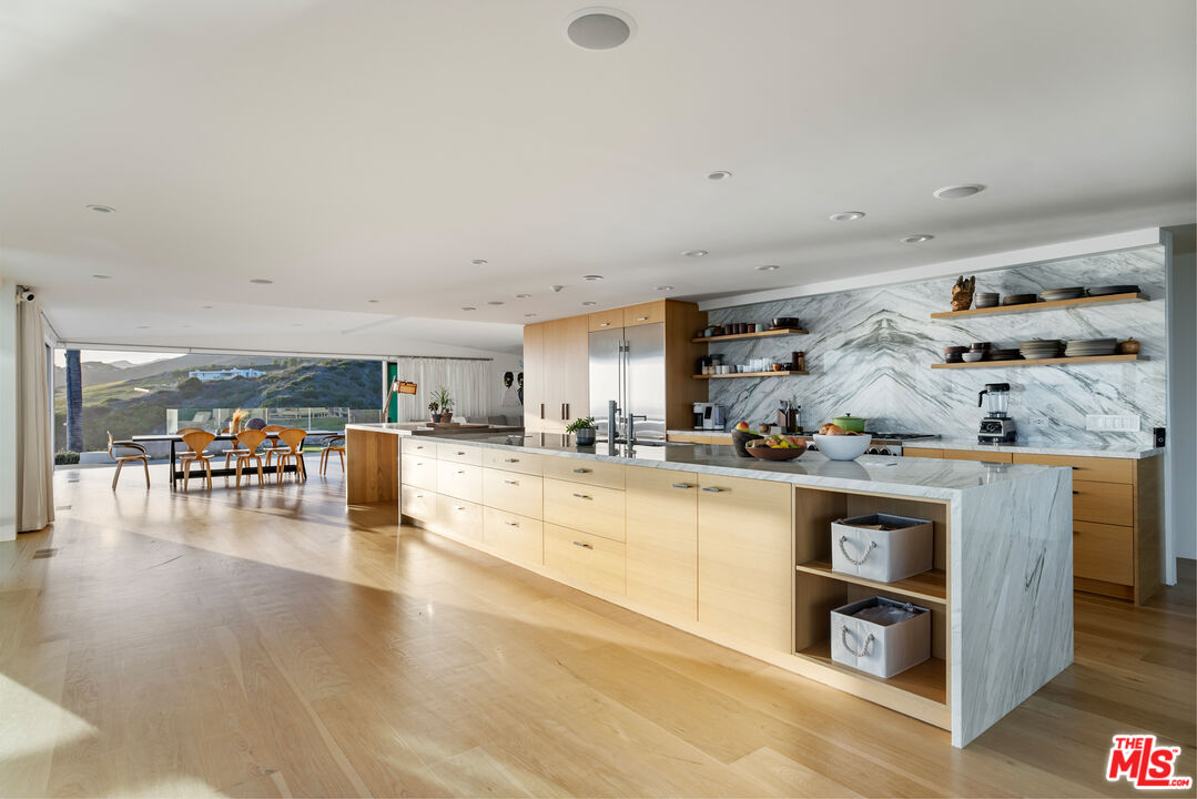 22407 Carbon Mesa Road Malibu, CA 90265 - Photo 9 of 33 a kitchen with stainless steel appliances granite countertop a stove and cabinets
