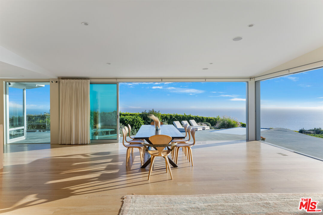 22407 Carbon Mesa Road Malibu, CA 90265 - Photo 10 of 33 a outdoor space with patio furniture and a garden