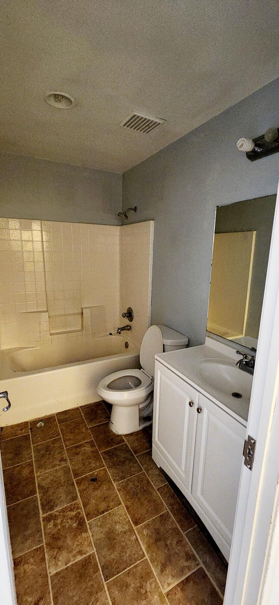 5817 Gem Court Lancaster, CA 93536 - Photo 11 of 26 a bathroom with a sink a toilet and a mirror