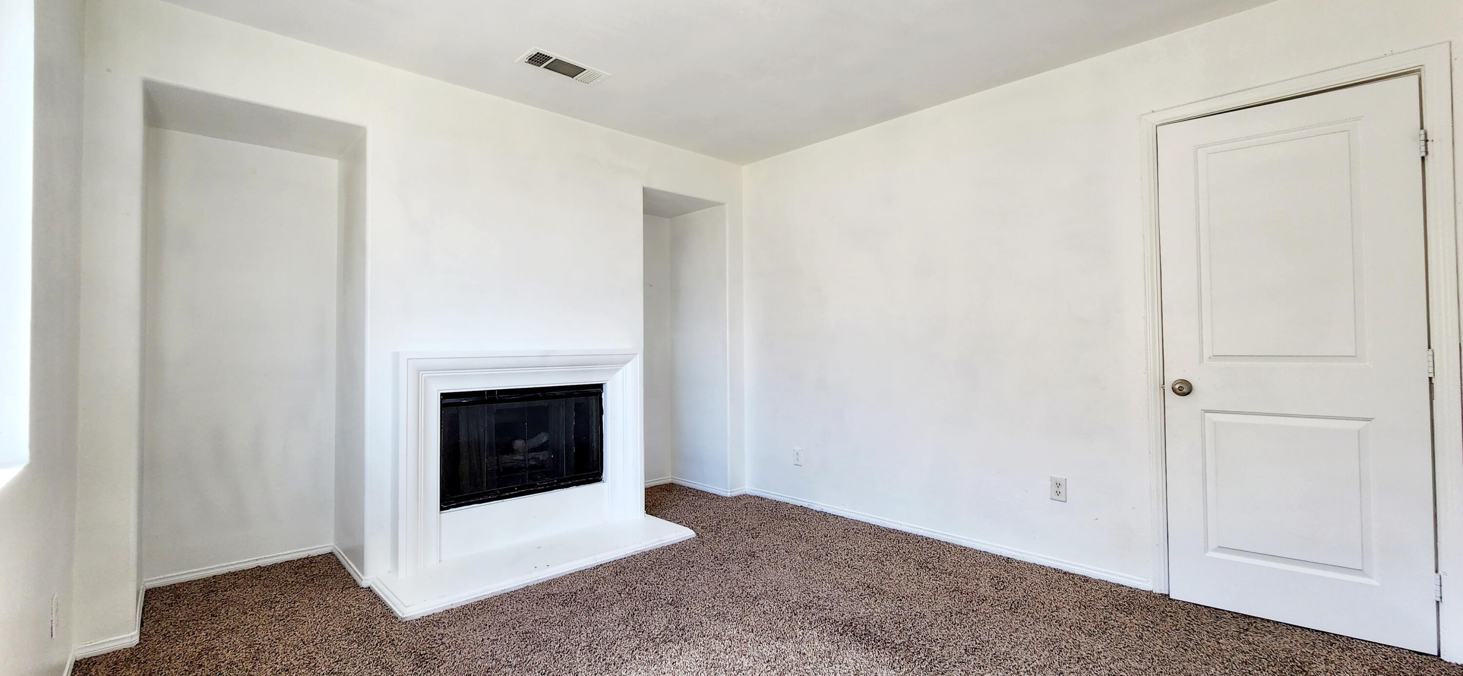 5817 Gem Court Lancaster, CA 93536 - Photo 17 of 26 a living room with a fireplace and a ceiling fan